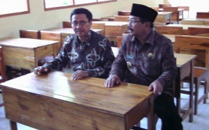 GUBERNUR JAWA TIMUR SOEKARWO DUDUK DI BANGKU SALAH SATU SEKOLAH ATAP DI LUMAJANG. (FOTO: AMIR LEA ELL RACHMAN)